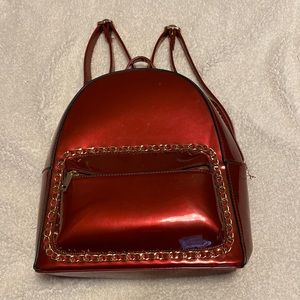 Red patent leather backpack with chain detail